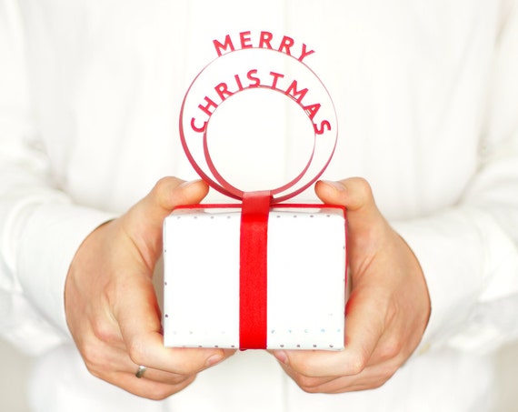 https://www.etsy.com/uk/listing/113576275/merry-christmas-paper-cut-gift-topper?ga_order=most_relevant&ga_search_type=all&ga_view_type=gallery&ga_search_query=printable%20christmas%20wrapping&ref=sr_gallery_17